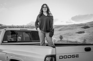 Black and white photo of a Dodge pickup truck against a rural landscape backdrop.