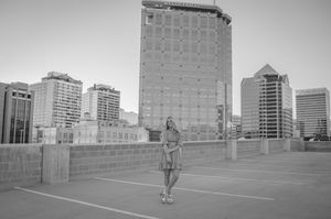 Black and white urban rooftop photography session with downtown skyline.