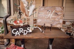 Rustic wooden wedding signs and decor with handwritten text displayed on brown planks.
