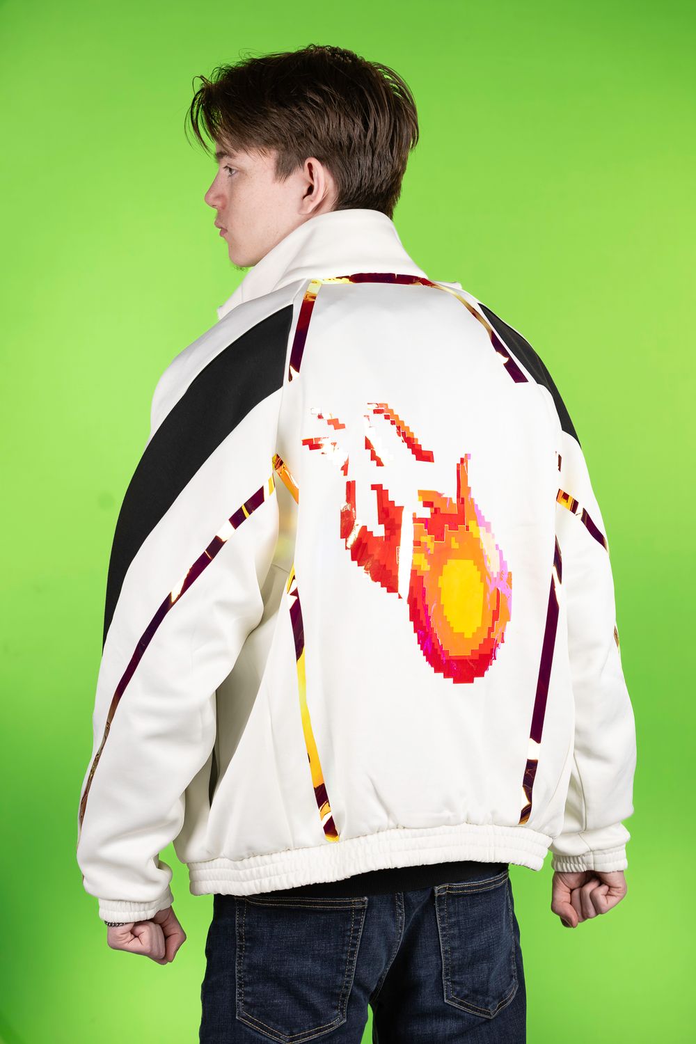 White jacket with flame design shown from back view against green background.