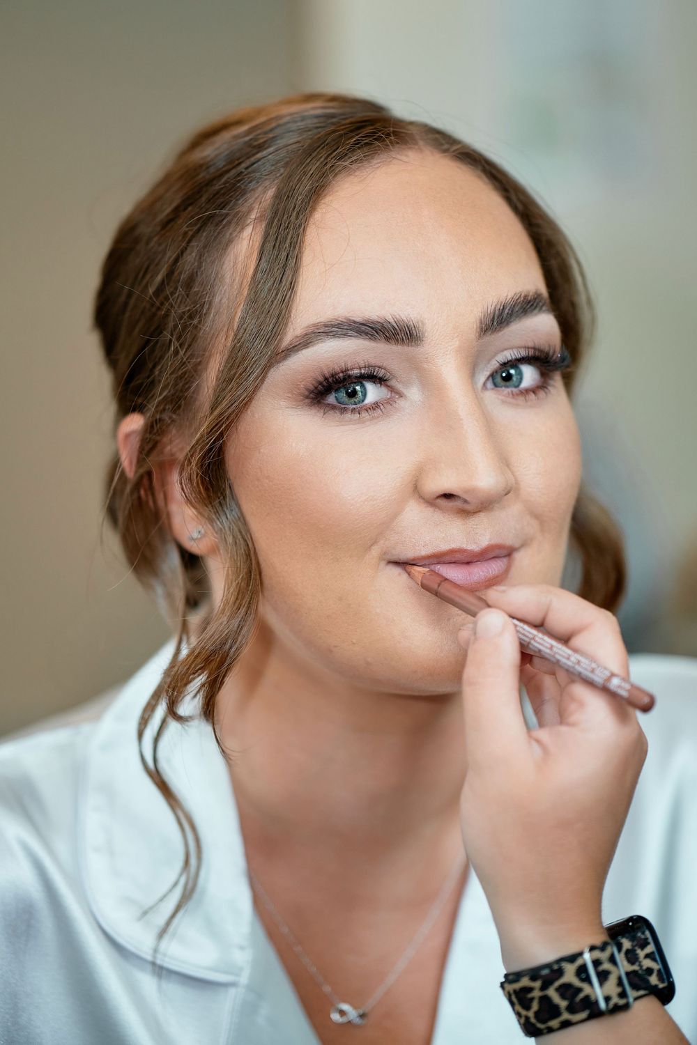 A makeup application tutorial showing lips being lined with a cosmetic pencil in multiple sequential steps.