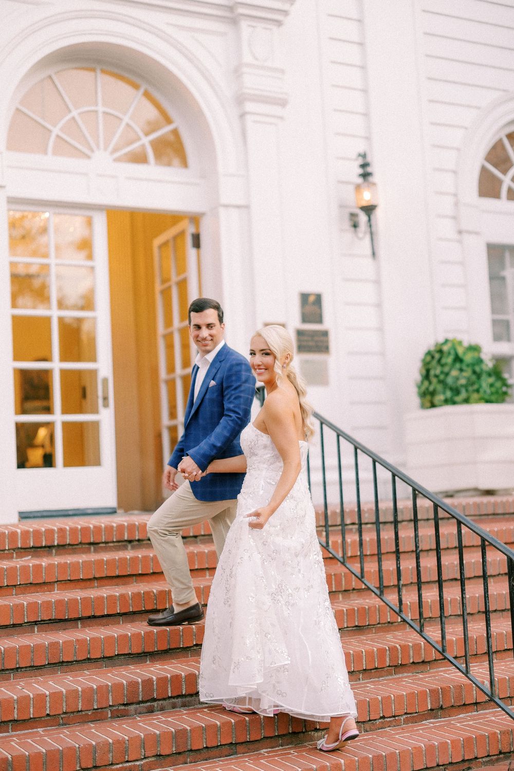 A series of four photos showing a couple dancing on the brick steps of a white colonial building with arched windows.