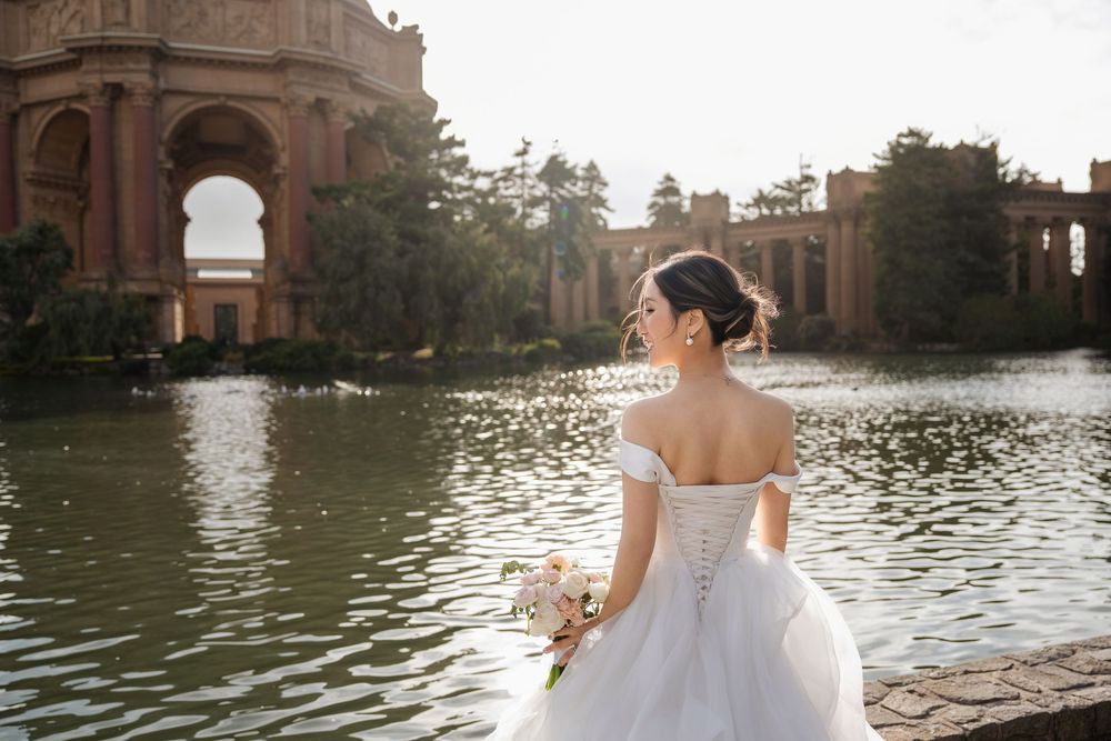 Couple capturing romantic moments at Palace of Fine Arts in San Francisco during sunset photography session.