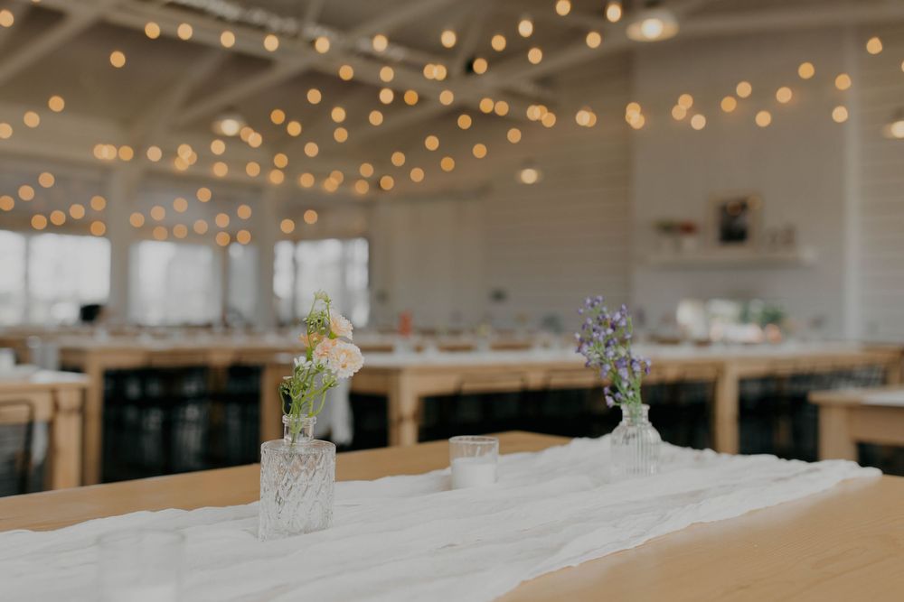 String lights create a warm ambiance across the ceiling of a reception venue.