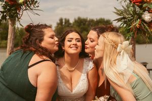 Wedding attendees share laughter and smiles during outdoor celebration.