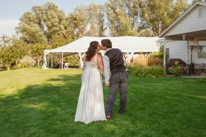 Romantic wedding photo sequence of couple embracing on a green lawn with white buildings in the background.