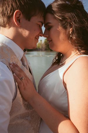 A romantic beachside photo sequence shows a tender moment between a couple in white attire.
