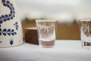 Row of delicate blue and white patterned votive candle holders in a rustic setting.