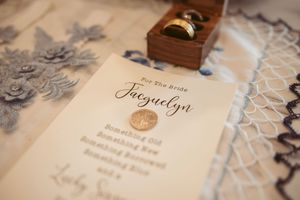 Several vintage letters and papers stained with age displayed in an overlapping arrangement on a lace surface.