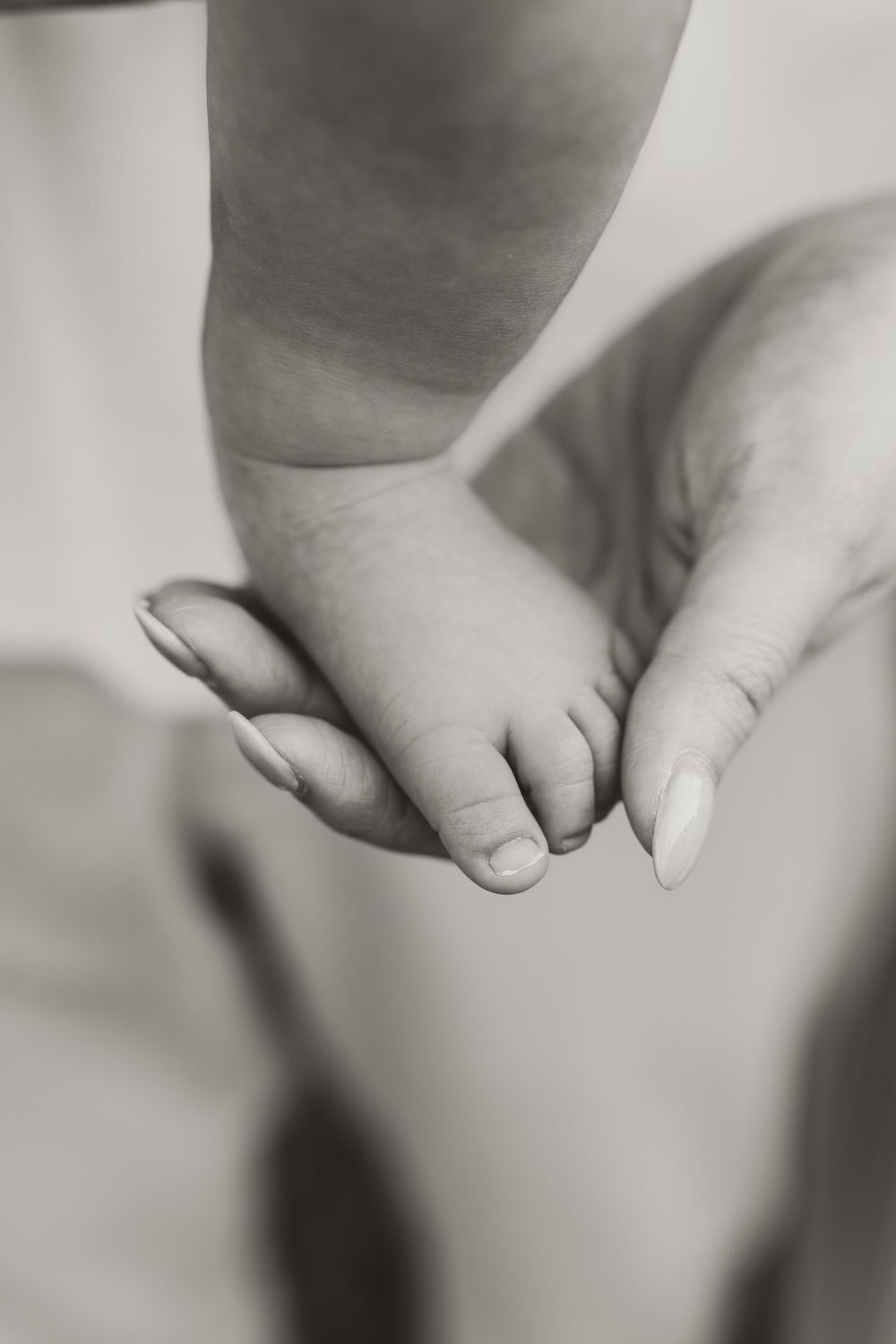 Close-up black and white detail shots of tiny baby feet and toes.