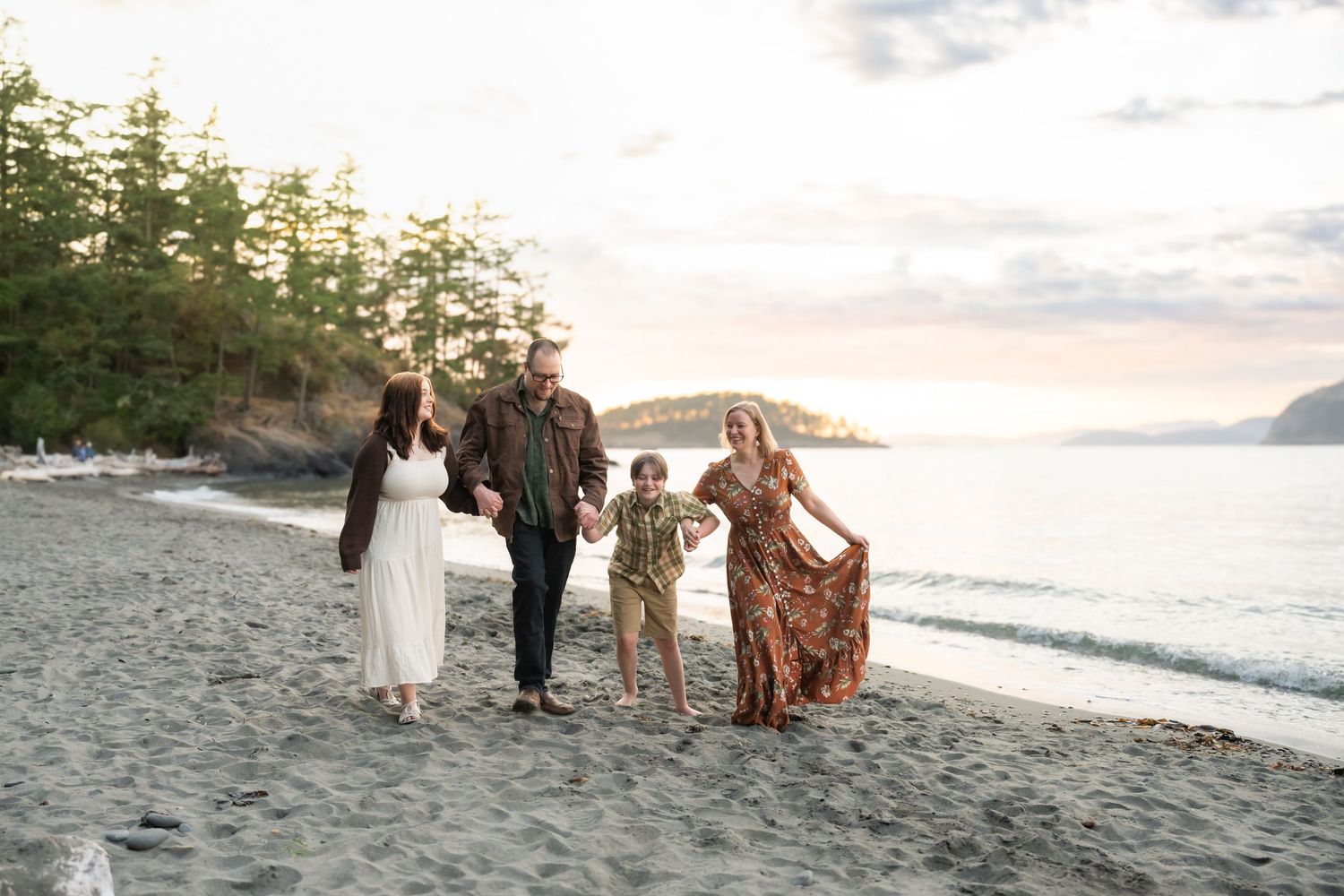 family plays on beach at deception pass state park during their family photos