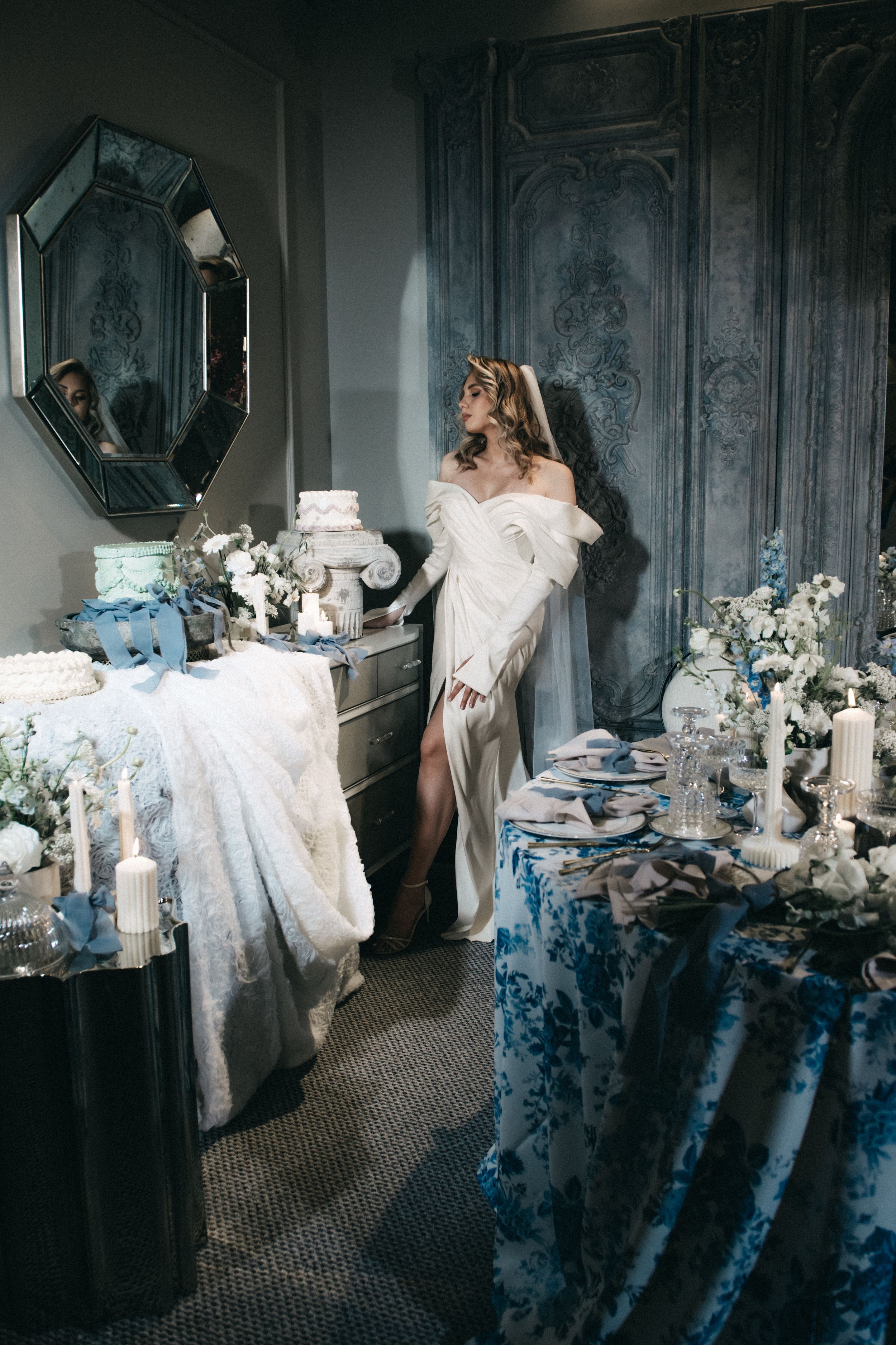 Fine art photography series shows a dreamy blue and white bedroom scene with ethereal flowing fabric and dramatic lighting.