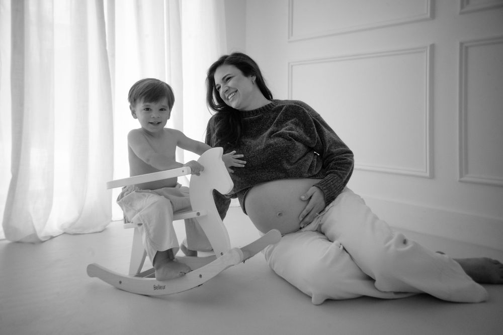Series of minimalist maternity photos in white room setting.