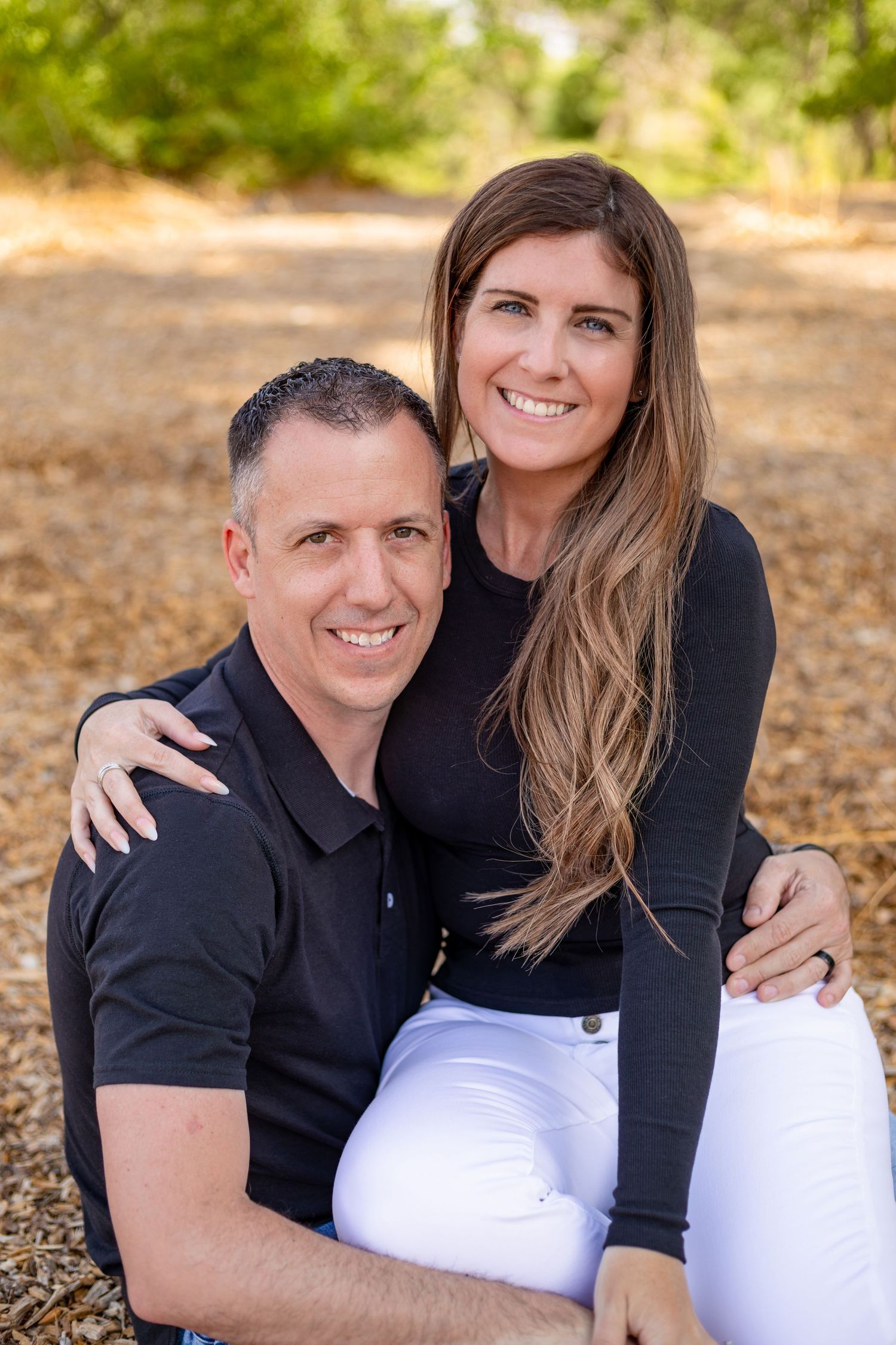 A couple wearing matching black tops pose together. Shot by Elle DeWeese Photography LLC in Albuquerque, New Mexico.