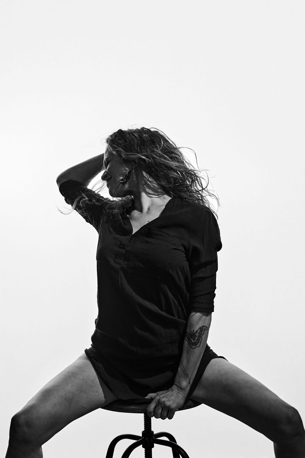 Artistic dance sequence captures flowing movement and dynamic poses in monochromatic studio setting.