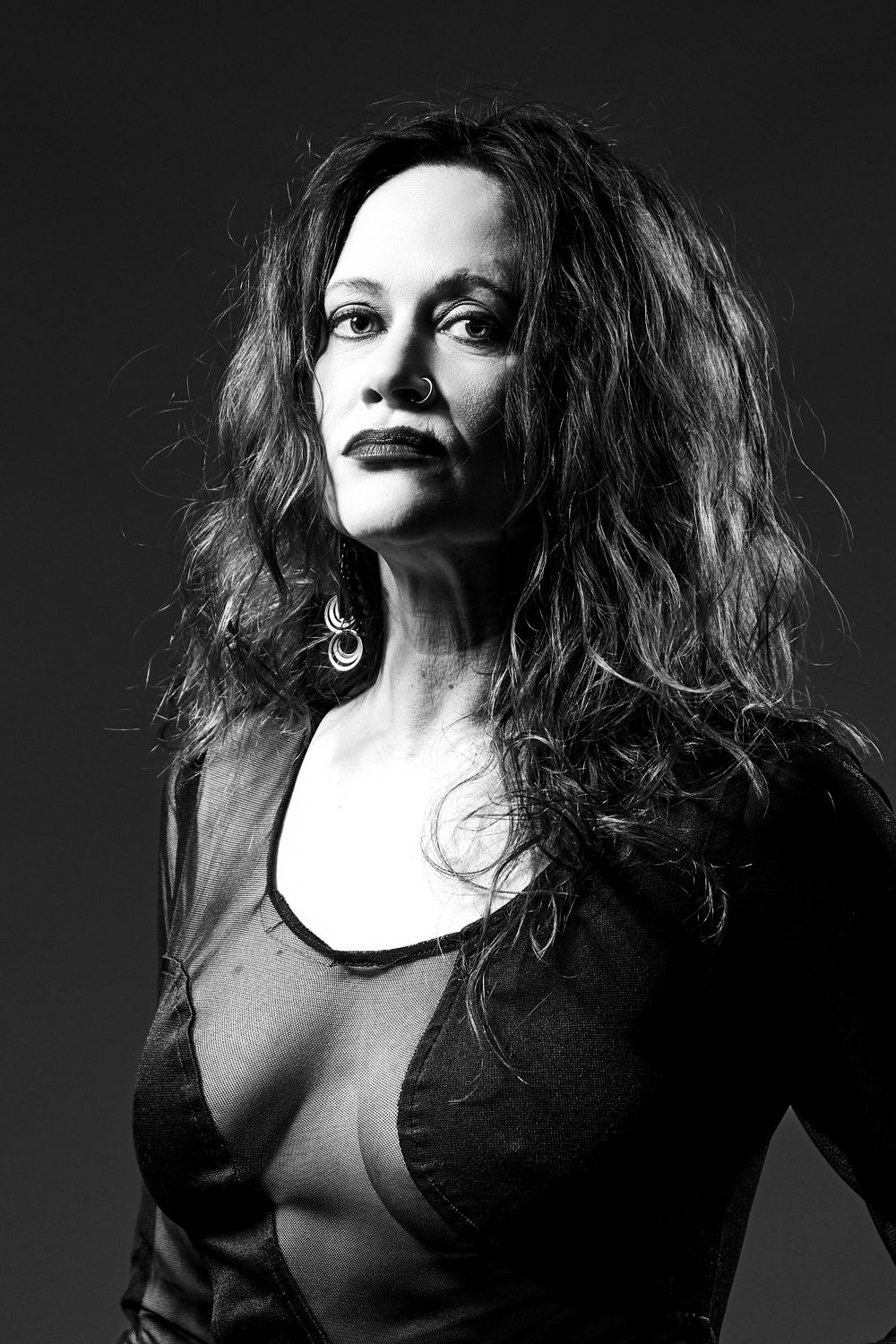 Dramatic black and white portrait series featuring expressive poses with tousled hair and dark clothing.