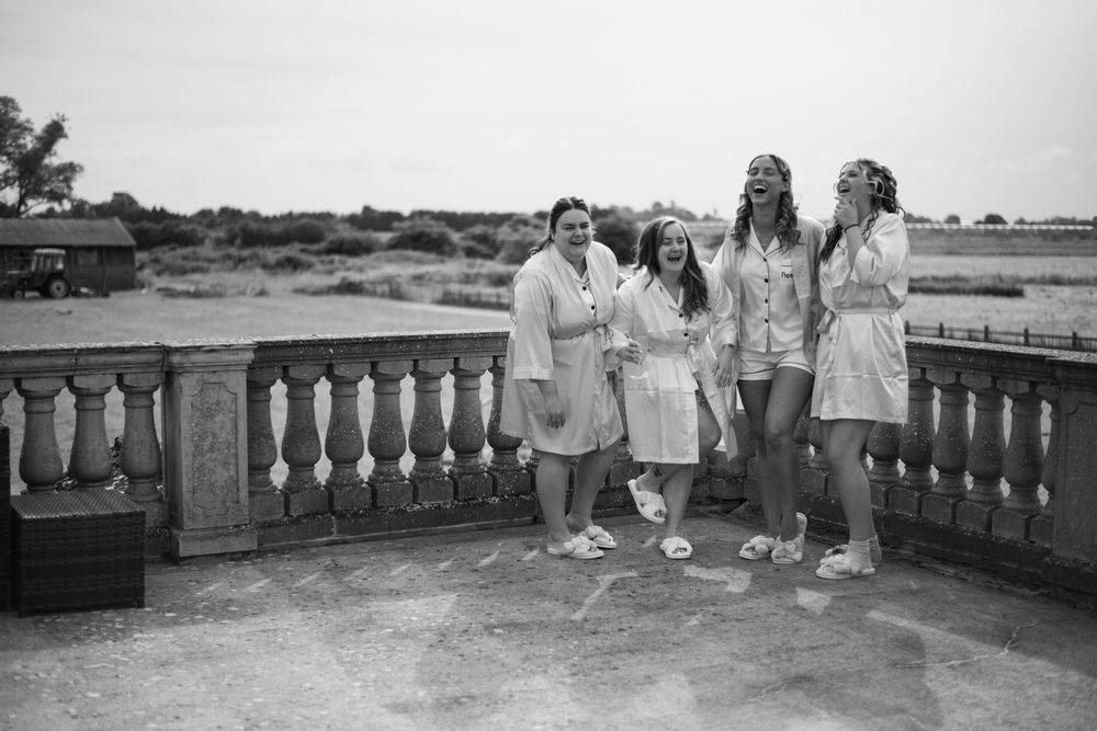 Group enjoying a casual gathering on a stone balcony overlooking a scenic view.
