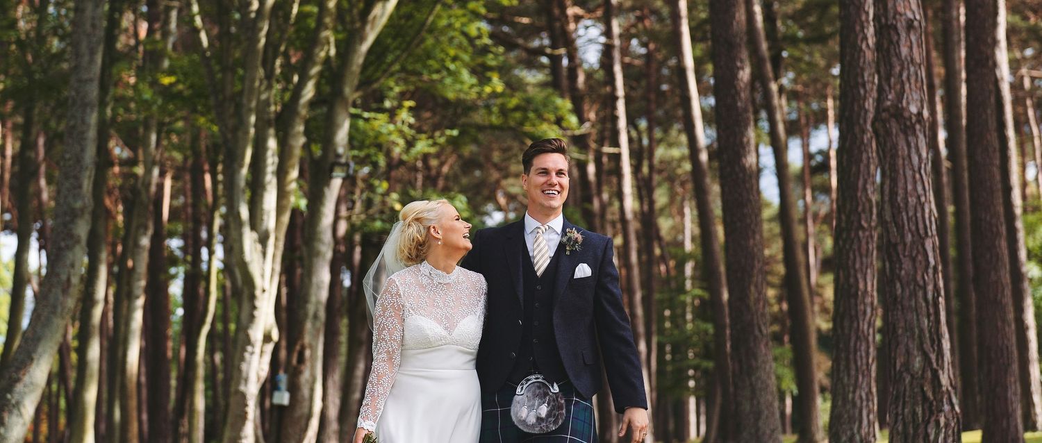 Cherry Tree Films - Bride and Groom walking during photo shoot at Archerfield House Wedding