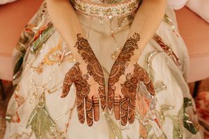 Close-up details of intricate henna designs, mehndi patterns, and traditional bridal jewelry on display.