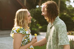 A series of candid outdoor photos showing a couple in floral and green attire sharing joyful moments together.