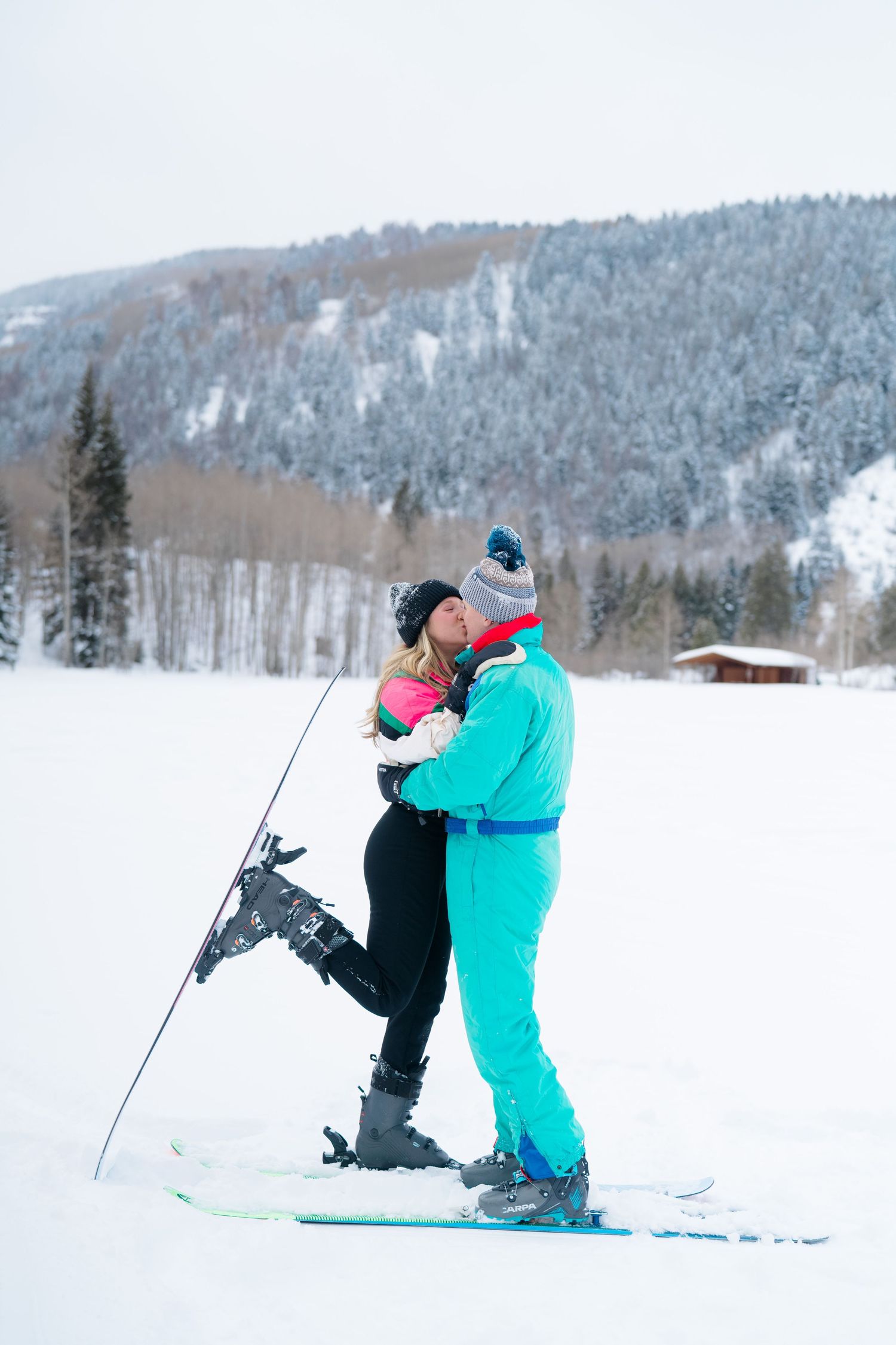 couple kissing and celebrating in ski suits