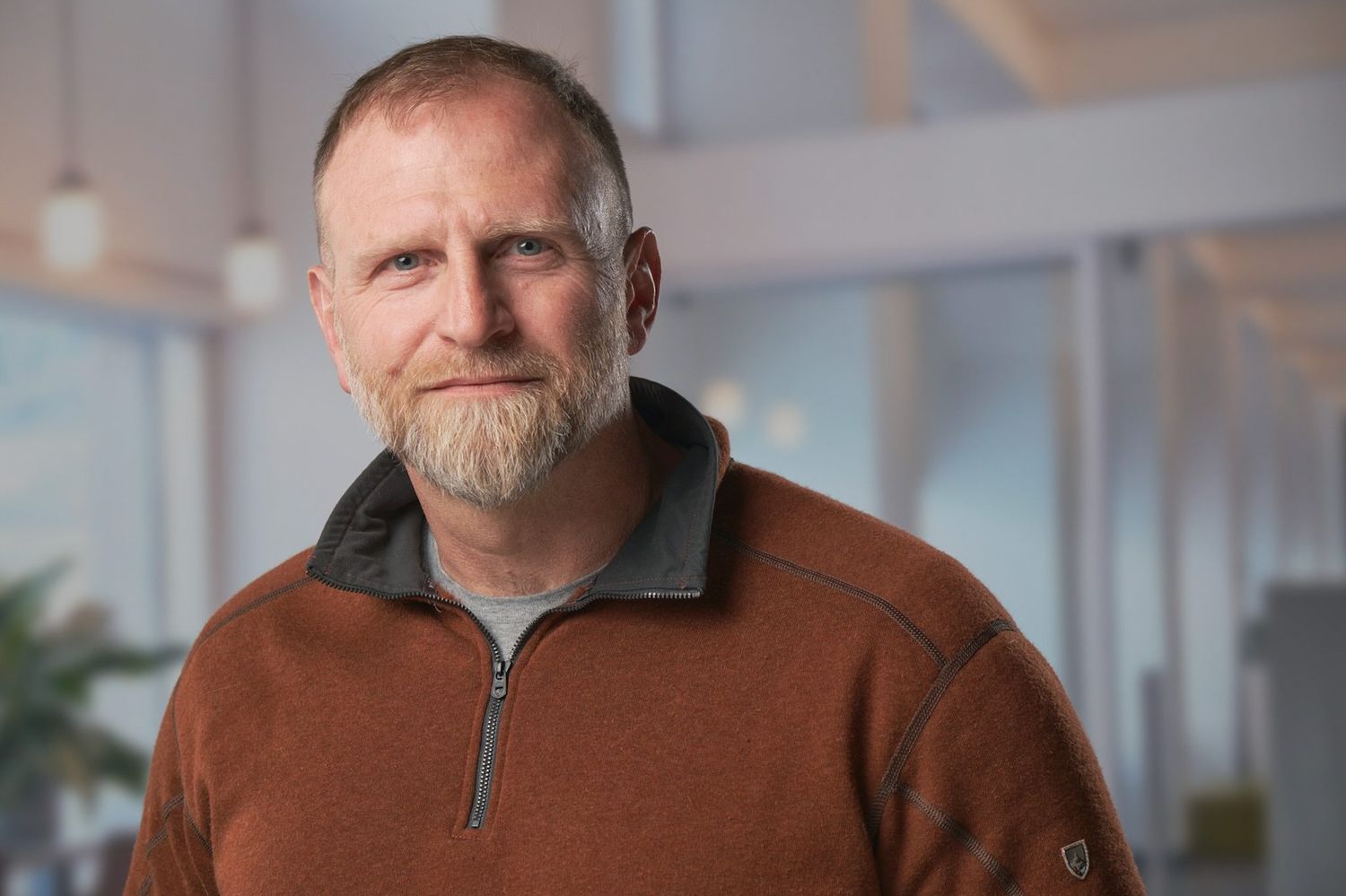 Professional headshot series showing casual business portraits in an office setting.