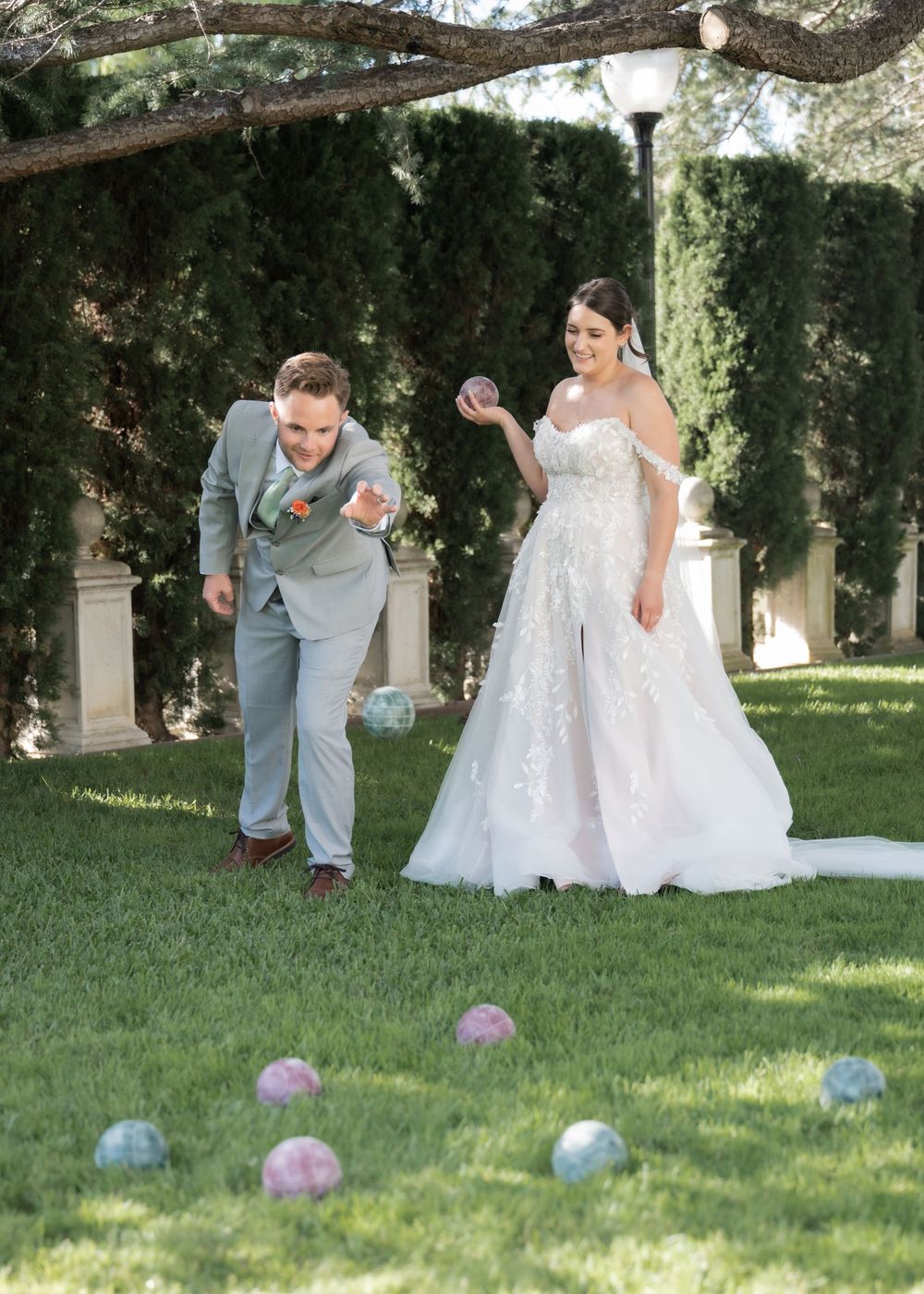 Bride and groom on the mansion terrace surrounded by greenery and blooms