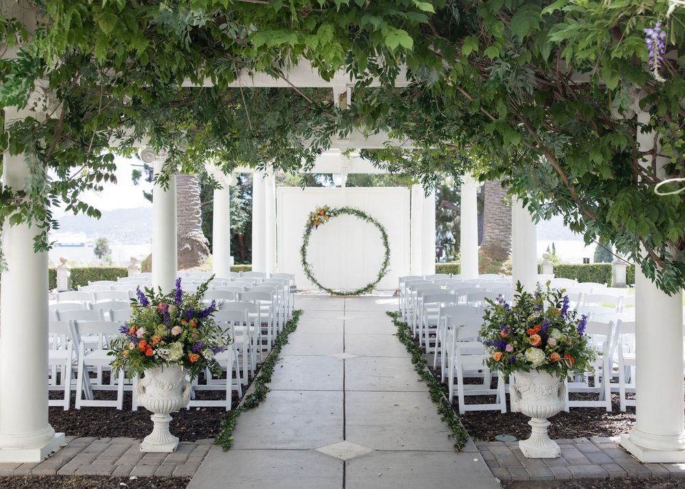 Outdoor wedding ceremony setup with chairs and floral arrangements at Jefferson Street Mansion