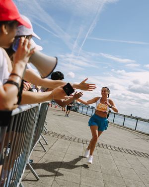 A sequence of action shots showing someone performing a cartwheel on a concrete walkway against a bright blue sky.