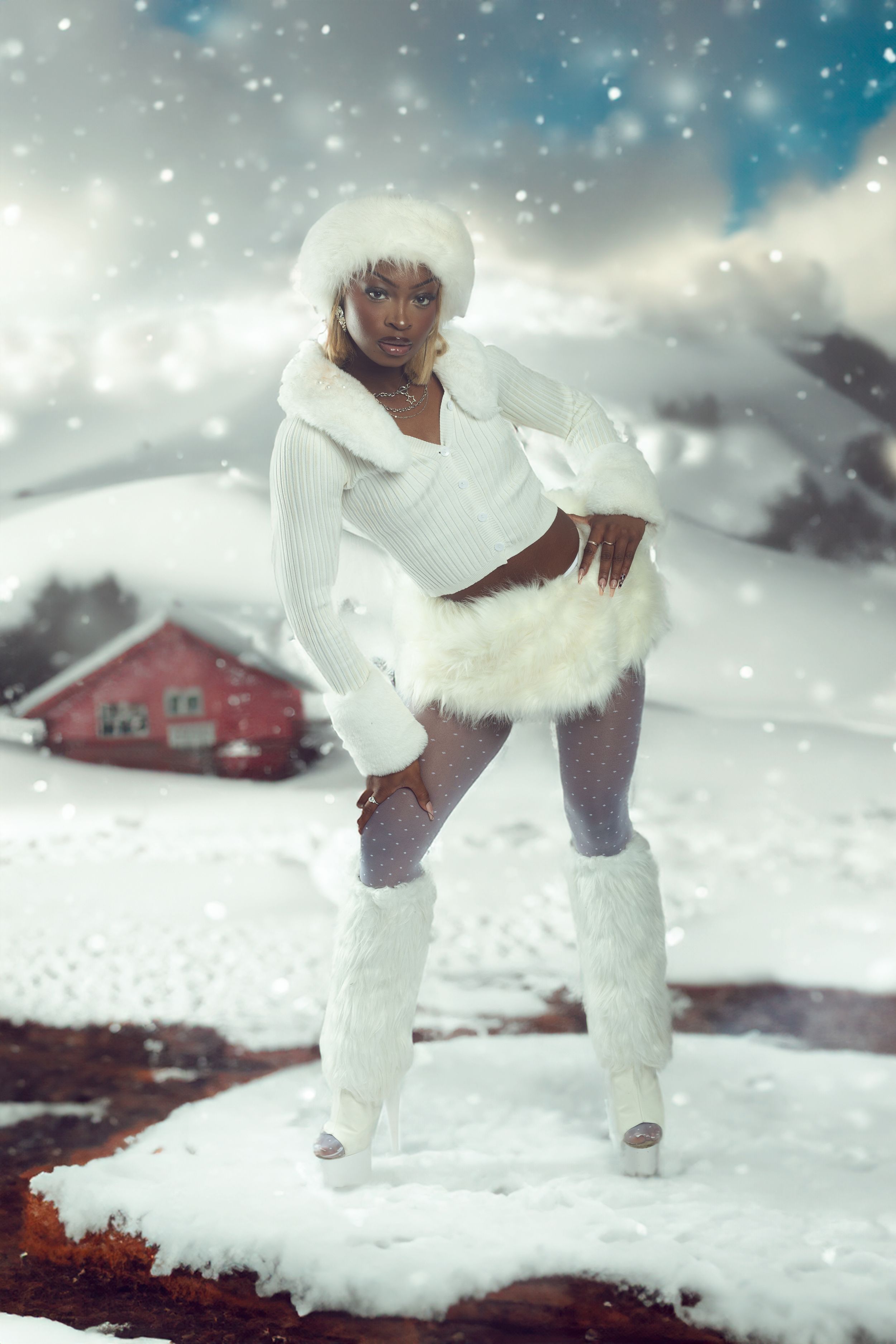 Figure in white winter clothing performs graceful dance moves in snowy landscape with red barn in background.