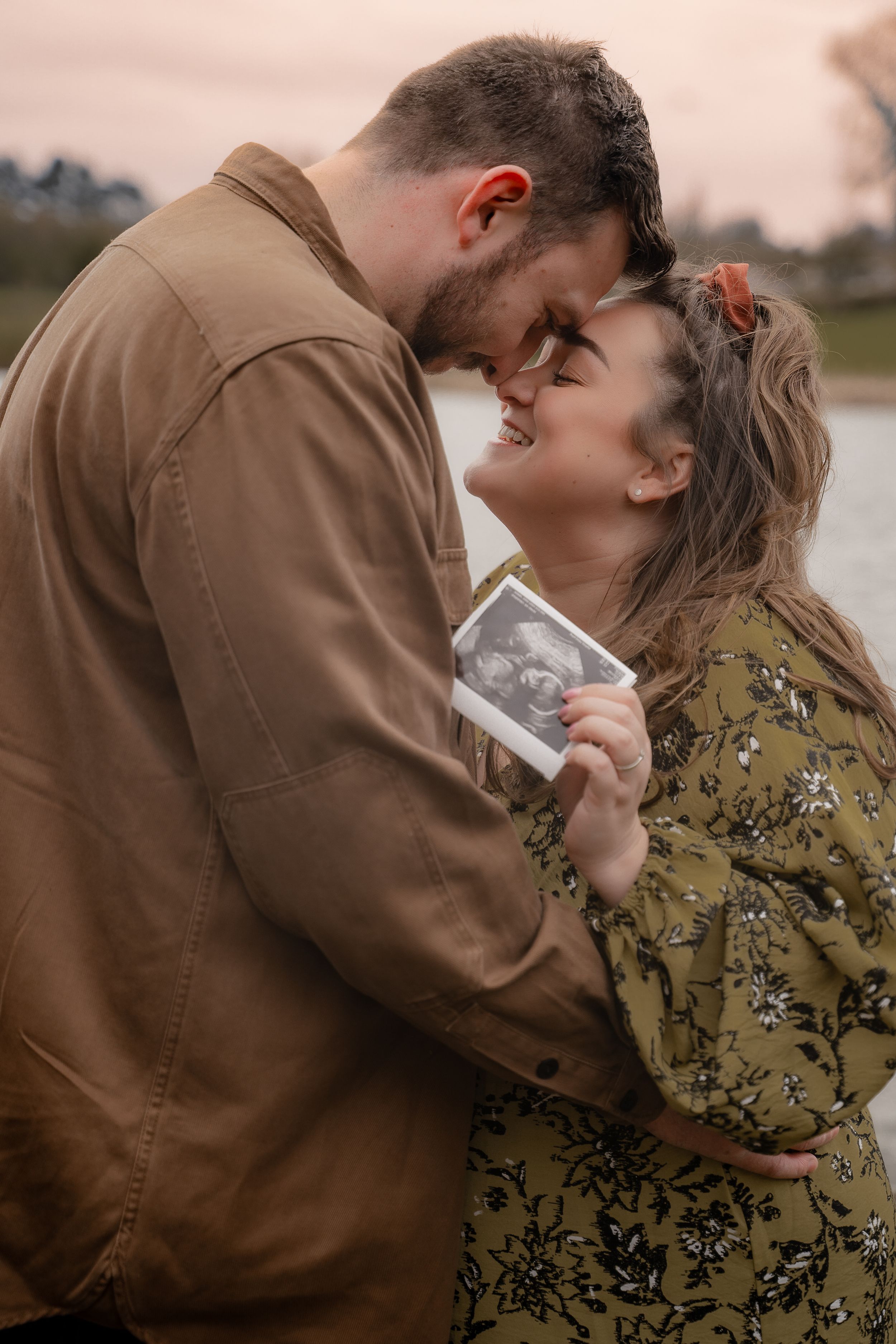 A romantic couple shares tender moments in a series of intimate outdoor portraits at sunset.