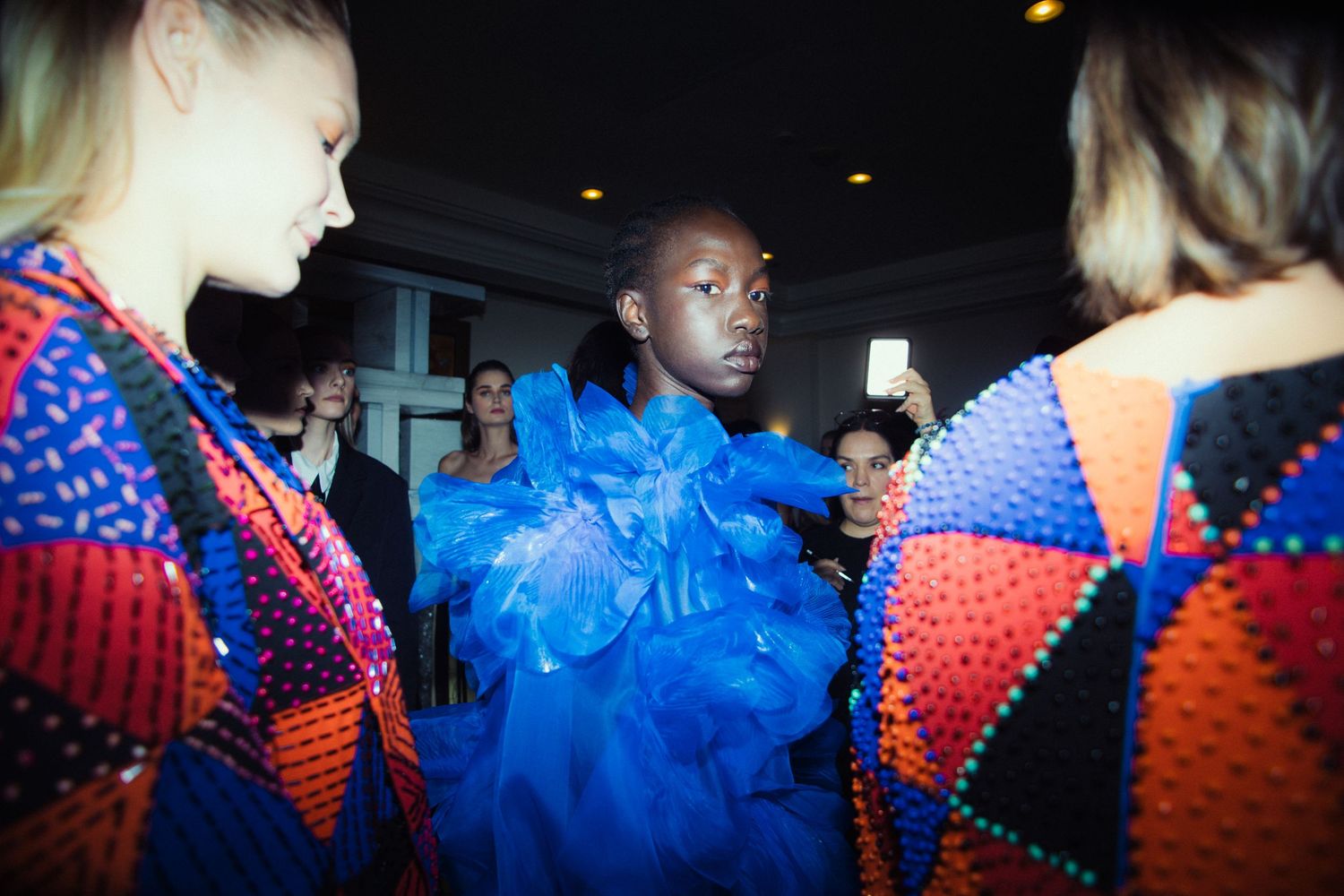 Backstage moment with models in blue feathered design | BTS fashion photography by Dario Hudon-Verrelli, Le Café Studio