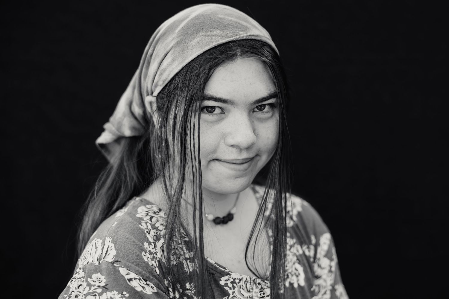 Seven black and white portrait photos showing similar poses against a dark background.