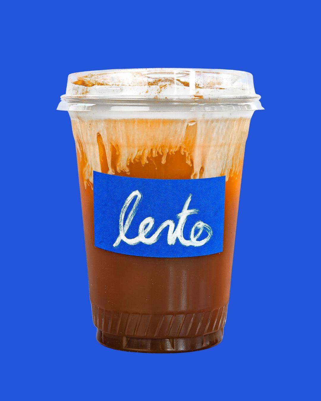 Iced caramel drink in a plastic cup with “lento” label on a blue background.