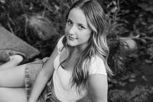 A black and white photo montage shows several natural expressions and poses against a dark background.