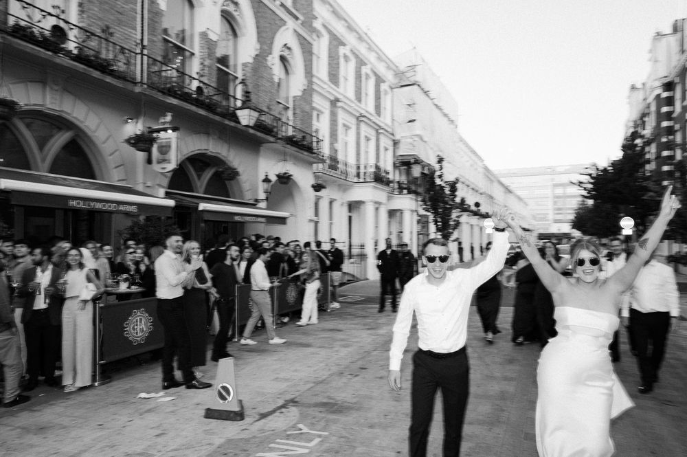 A black and white panoramic sequence of street scenes showing a period cityscape with pedestrians and buildings.