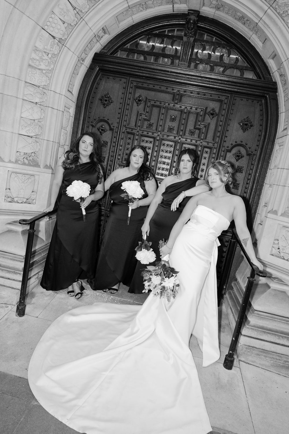 A playful wedding sequence shows a dress twirling across architectural archways in black and white photography.
