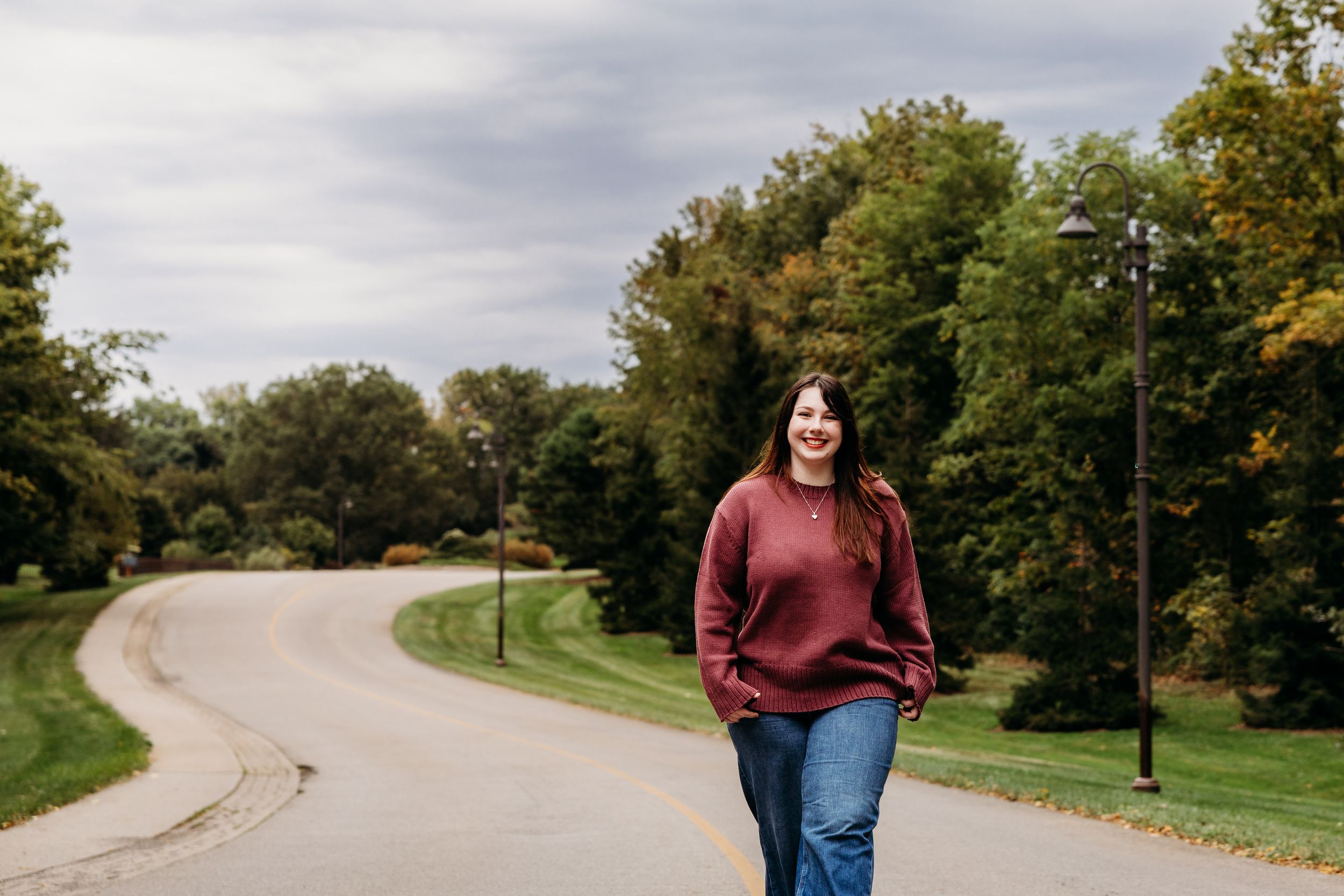 An autumn engagement shoot in a scenic park with warm fall colors and a winding path.