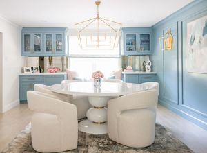 A light and airy interior design collage featuring white swivel chairs, blue walls, and contemporary lighting fixtures.