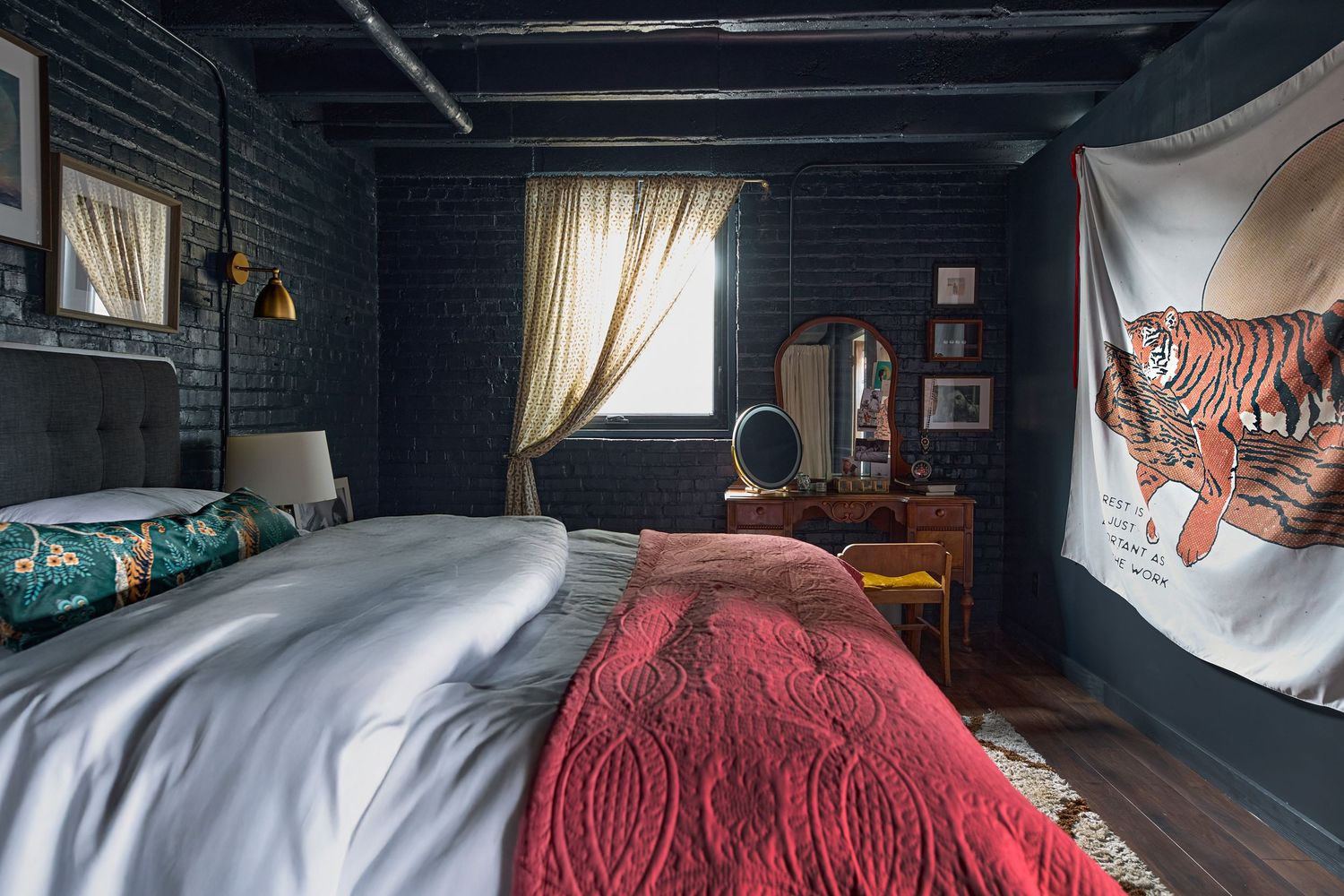 Dark basement room with exposed beams and scattered furniture against painted walls.