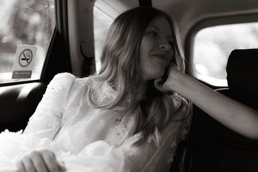 Black and white photo sequence showing changing laughing expressions in the passenger seat of a car.