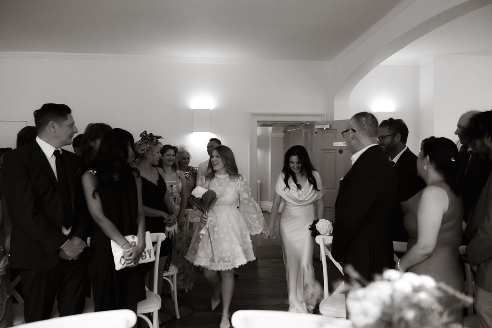 A sequence of wedding reception photos showing guests dancing and celebrating in a dimly lit indoor venue.