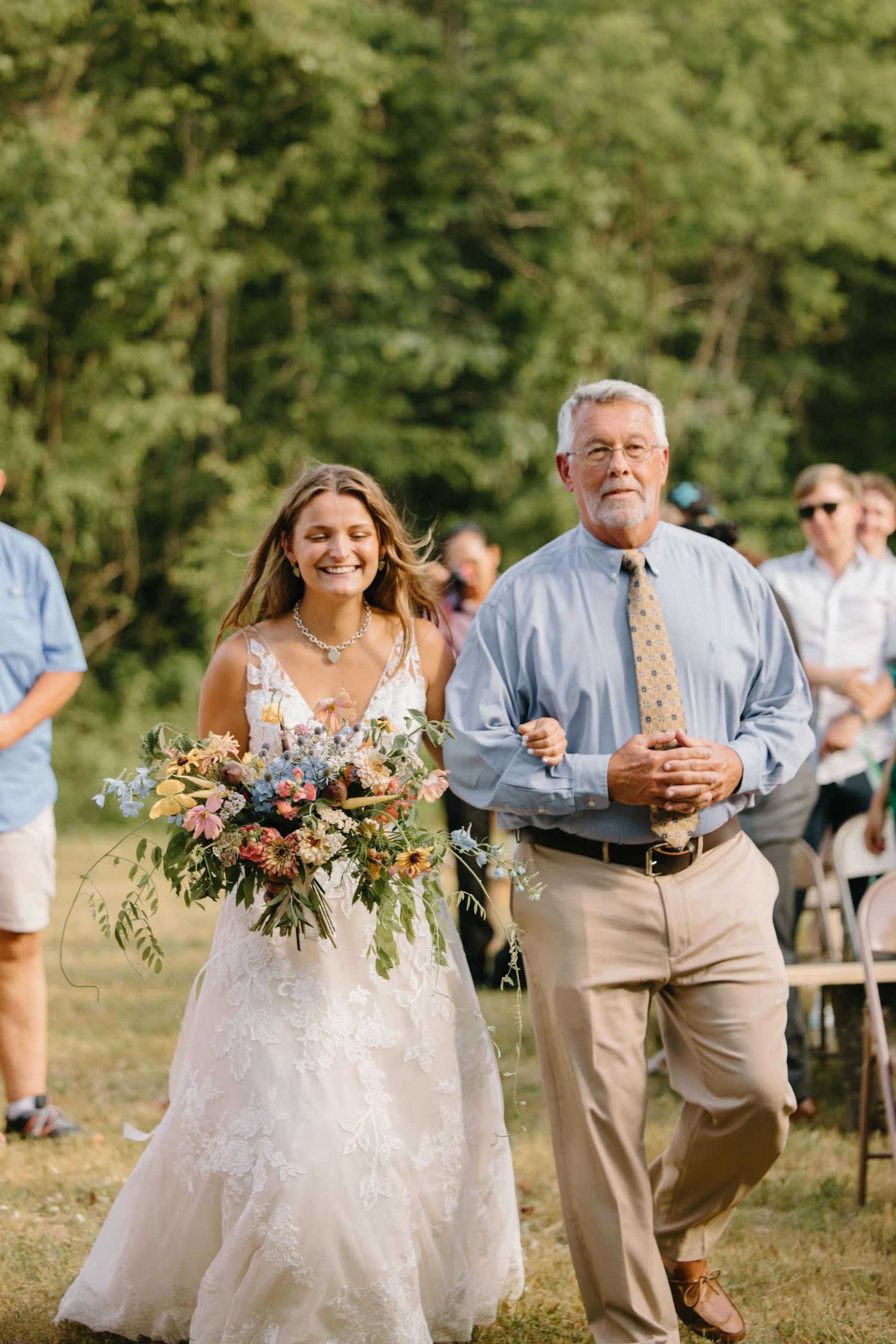 A series of wedding party photos showing guests in light blue attire and floral bouquets in an outdoor garden setting.