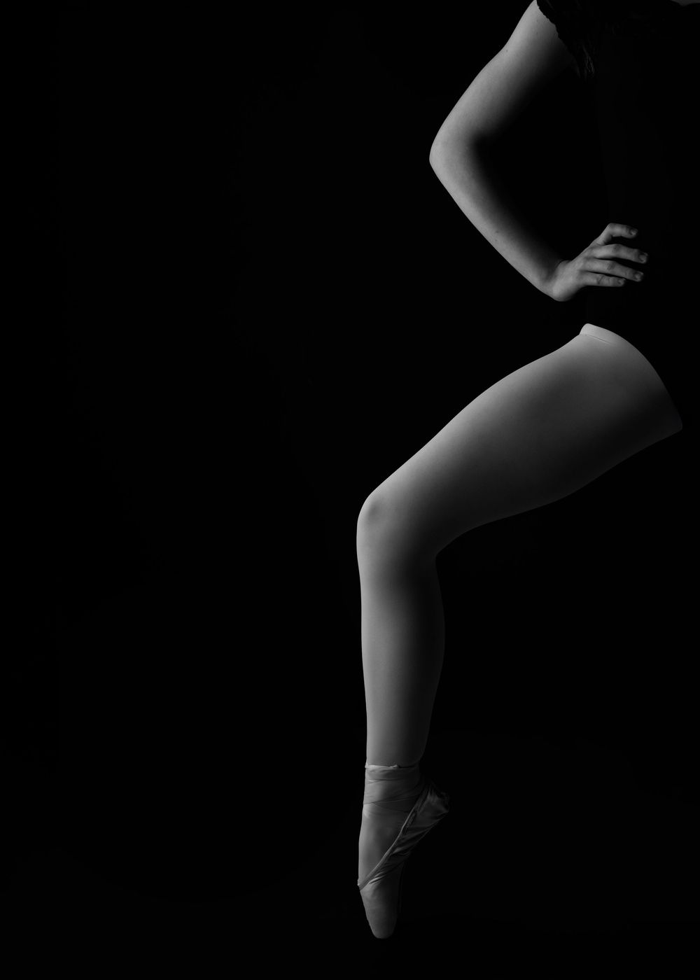 A series of black and white close-up photographs showing the graceful curves and shadows of ballet shoes.