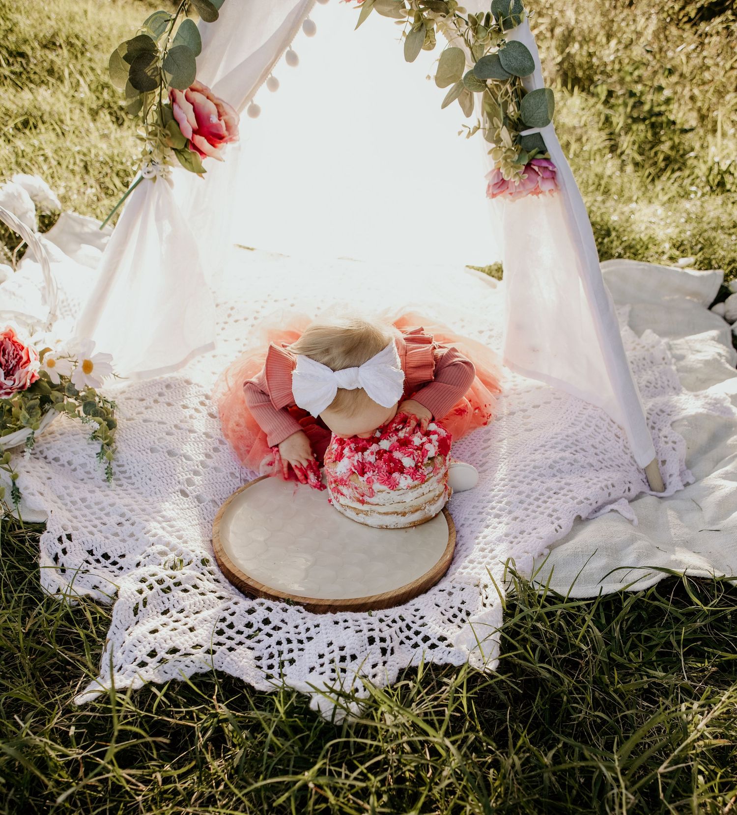 Outdoor cake smash with teepee. Head first in the cake
