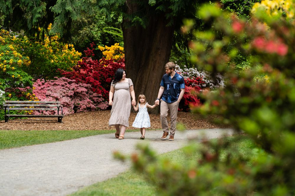 Family walking hand in hand at the Seattle Arboretum.