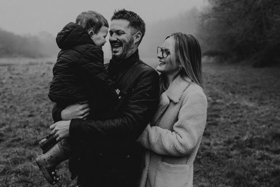 Intimate black and white portraits captured in a natural outdoor setting during golden hour.