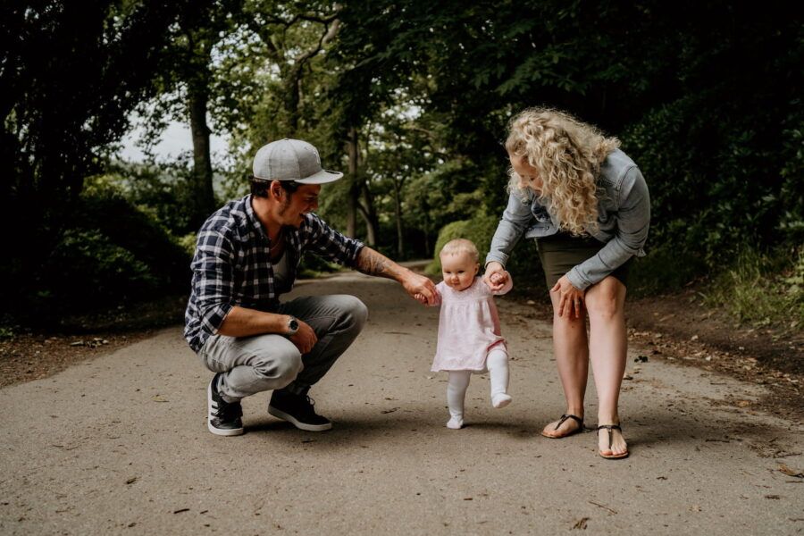 Candid family interactions captured on a nature path during an outdoor photo session.