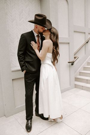 Artistic wedding sequence showing tender moments on white stairs.