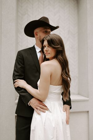 Intimate wedding photos of a couple against a light background, featuring western-style formal wear.